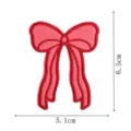 Detailed close-up of pink embroidered bow patch, showing red stitching and exact dimensions. - DW9806-25