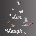 Close-up detail of silver mirror wall stickers featuring butterfly shapes and inspirational words. - Silver