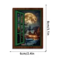 Close-up of a glowing Christmas window fridge magnet showing a snowy village scene with moon. - FGMZCT220