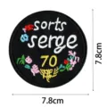 Round embroidered patch black cloth sticker with floral details and letters close up view - Round Floral(DW9089-8)