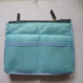 Detail view of the multi-functional organizer bag insert with zipper and mesh pockets. - M / Sky Blue