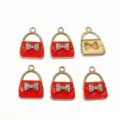 Detail view of red enamel bow alloy bag charm pendant jewelry accessories, exquisite work. - Red