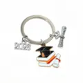 Graduation keychain detail view showing metal book cap and 2026 charms for student gifts. - Diploma Certificate Pendant (SG-F6-23-P3-54) / 1 Piece/Pack (21x21mm)