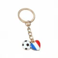 Gold metal keychain with soccer ball and French flag heart pendants, smooth oil drop detail. - France Flag Style