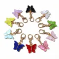 Close-up detail of colorful acrylic butterfly charms with gold lobster clasps for DIY jewelry. - Butterfly Pendant (Random Mixed 1)