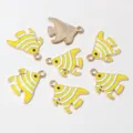 Close-up detail of alloy drop oil striped sea fish charms, ideal for DIY jewelry making. - Yellow Stripes