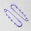 Detail shot of purple safety pins with hanging loops, ideal for DIY doll pendants. - AJ4-41