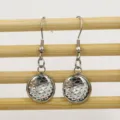 Detailed close-up of stainless steel round earrings featuring a shiny fish scale pattern. - 12mm / 9