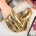 Close-up of shiny gold metallic full-finger PU gloves, stage performance accessory detail. - Gold