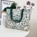 Large capacity canvas tote bag for women with trendy doodle design and green shoulder straps. - Green Graffiti