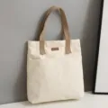 Casual canvas tote bag for women, large capacity commuter shoulder bag with front pocket. - Off White