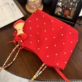 Red floral canvas tote bag with colorful woven strap and cute plush pendant for daily commute - Apple Pendant / Colorful Rope Red