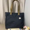 Minimalist black canvas tote bag with khaki straps, casual commuter handbag for daily use. - Black