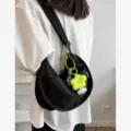 Minimalist black canvas shoulder bag for women, casual hobo crescent crossbody bag with cute charm. - With Charm / Black