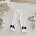 Infant baby ribbed cotton leggings with cute black ankle bows, soft and elastic toddler pants. - 66cm / Bottoms / White