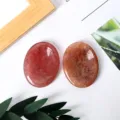 Natural crystal worry stone polished oval thumb massage gemstone for stress relief and calming use - Strawberry Quartz