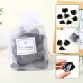 Natural black obsidian raw crystal stones set in a white mesh gift bag for healing. - Black Obsidian Raw Stone Gift Bag