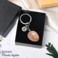 Natural crystal stone keychain featuring Scorpio constellation charm and flower agate tumbled stone. - Scorpio (Flower Agate)