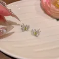 Close-up detail of stylish double-layer enamel butterfly earrings, exquisite and elegant jewelry. - Double Layer Butterfly / White K/Silver