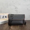 Detailed shot of a vintage style men's messenger bag with adjustable strap and soft leather. - Black and Brown