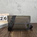 Detail close-up view of olive green retro messenger bag, casual soft leather bag. - Green and Grey Crazy Horse