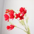 Close-up detail of artificial cosmos flower, long branch silk floral decor for home. - Bright Red