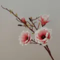 Close-up detail of artificial magnolia branch, pink and white EVA silk flower for home decor. - Pink