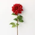 Detailed close-up of a single artificial red dahlia flower with green leaves for home decor. - Dark Red