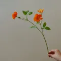 Artificial ranunculus flower branch detail shot, perfect for DIY crafts, decor and photography. - Orange