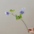 Detailed view of artificial silk flower branch with blue peony and green leaves for DIY decor. - Purple Blue Zirconia