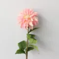 Detailed close-up of a single artificial pink dahlia flower with green leaves for home decor. - Pink