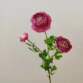 Close-up detail of three-head artificial ranunculus flower, silk floral decor for background. - Dusty Purple