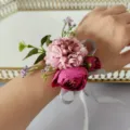 Artificial flower wrist corsage detail view, elegant pink and rose red floral wristband for party. - Wrist Corsage XH084-5