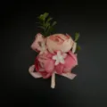 Pink artificial flower boutonniere close-up detail for wedding groom and photography props. - Corsage / Deep Pink