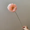 Detail view of artificial pink poppy flower on a long stem, elegant interior decor closeup. - Medium Coral Pink