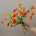 Detailed view of vibrant orange artificial flower bouquet, perfect for home decor and gifts. - Orange