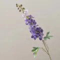 Close-up detail of artificial purple delphinium flower stem with buds for home decor. - Purple