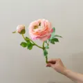 Artificial camellia flower detail, pink silk floral branch with bud and green leaves close up. - Champagne