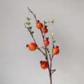 Artificial pomegranate branch detail, realistic red fruit decor for home and window display. - Orange