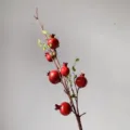 Artificial pomegranate branch detail showing red fruits and green leaves for home decor. - Red