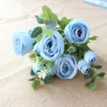 Close-up detail shot of artificial blue rose bouquet with eucalyptus leaves and floral decor. - Blue