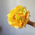 Close-up detail shot of bright yellow artificial silk hydrangea flower ball for decor. - Dark Yellow