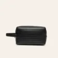 Black travel toiletry bag with stylish ribbed design and side handle, portable cosmetic organizer. - Black