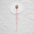 Silicone pacifier clip detail view, pink cartoon design with wooden bead and metal clip. - Wood Clip Style / Light Pink
