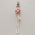Handcrafted knitted flower pacifier clip detail, soft fabric baby teether chain view. - Pink Flower