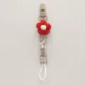 Handcrafted knitted flower baby pacifier clip with cute plaid strap and secure plastic clasp. - Red Floral Plaid