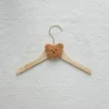 Wooden children clothes hanger with cute plush bear head detail for nursery room organization. - Coffee Bear Head / Coffee