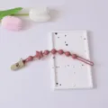 Baby Silikon Schnullerette, altrosa Beisskette mit Sternperlen und sicherem Clip für Babys. - Kunststoffklammer / Burgunderrot
