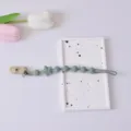 Grüner Silikon Schnullerhalter für Babys mit Sternperlen, sichere Beißkette für Kinder. - Kunststoffklammer / Armeegrün