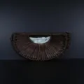 Hand-woven semi-circular rattan crescent handbag detail showing natural texture and light lining. - Brown
